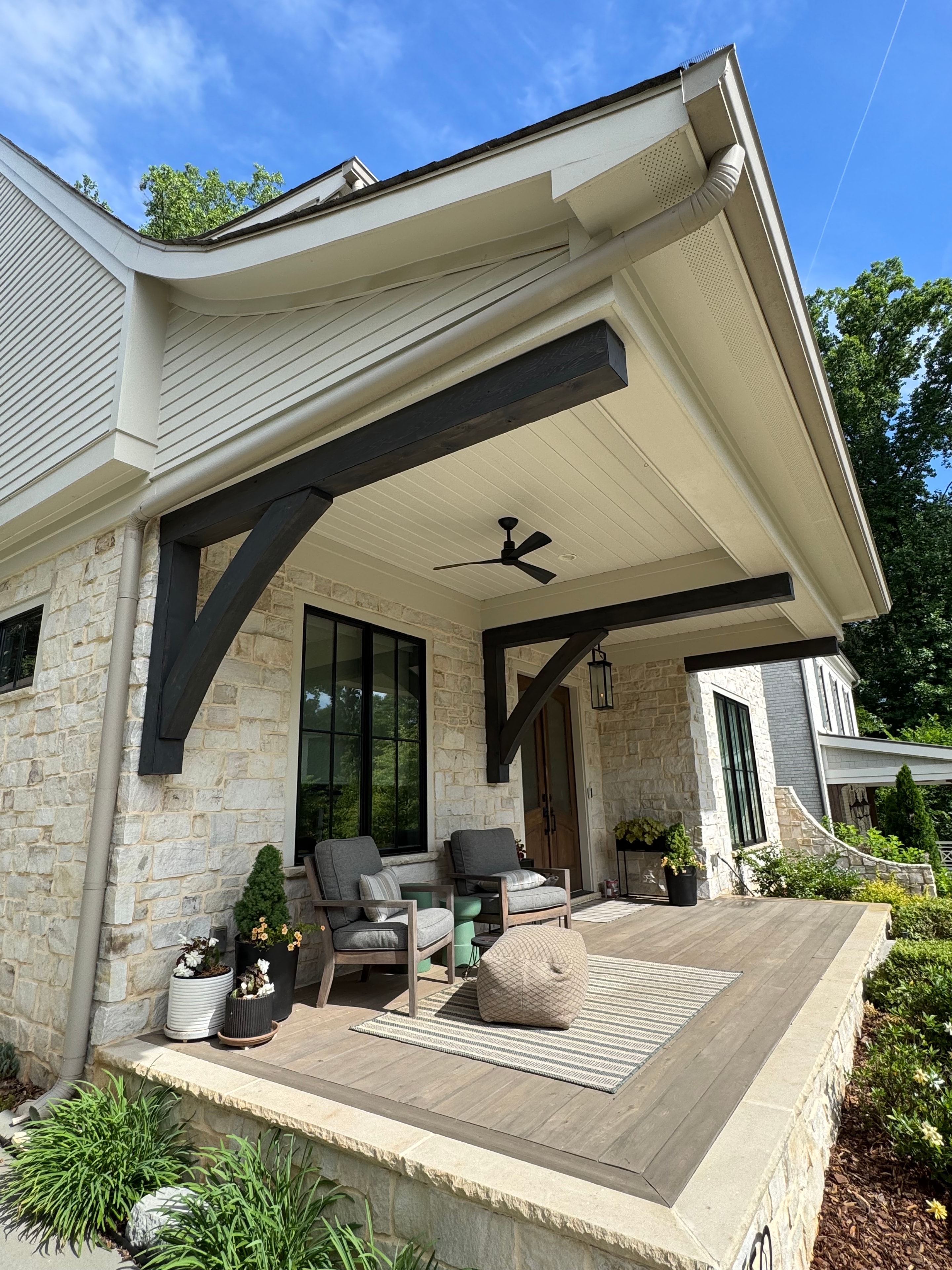 Painted home exterior with covered patio and stone accents